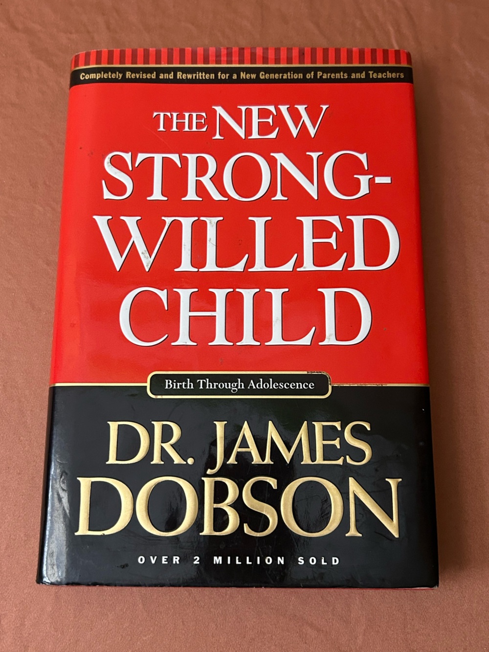 The New Strong-Willed Child by Dr. James Dobson — Red and Black Hardcover